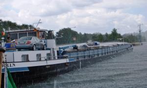 Passing Barge in the pouring rain- Look at it bounce off the water and cargo roof