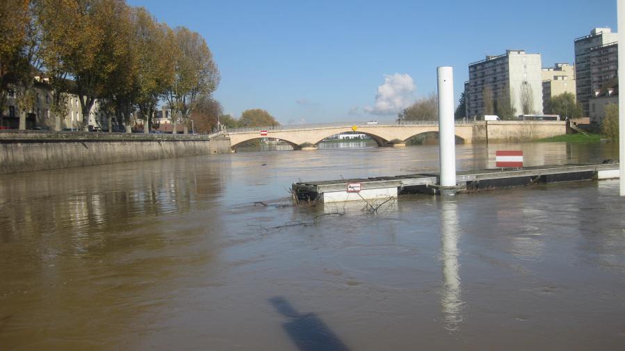 Current flies past the pontoons carrying branches