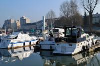 Marie Ange waves good bye- note our empty mooring beside their boat